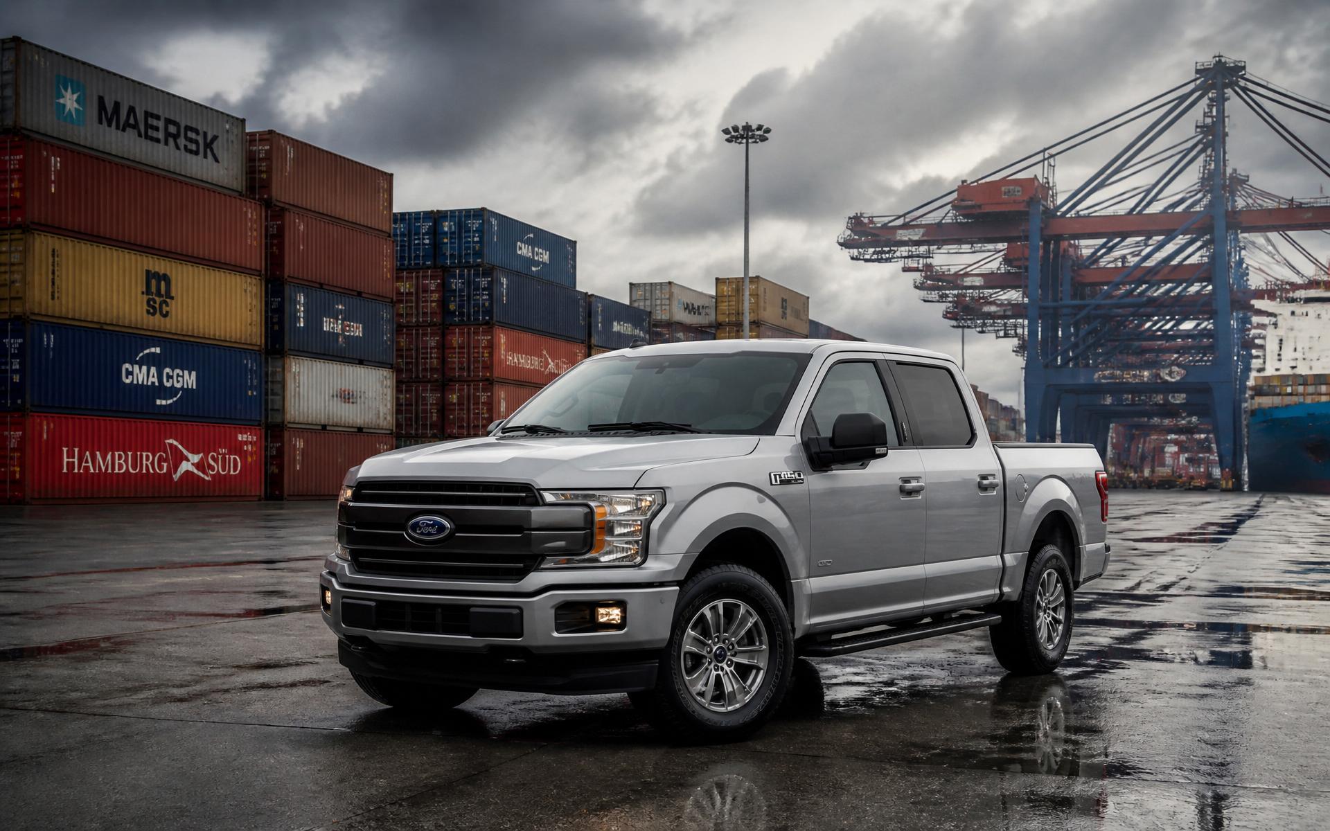 Silver Ford F-150 at an industrial shipping port